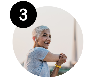 Woman stretching before a run with earphones, smiling